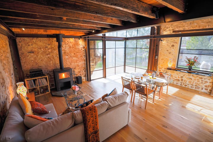 "The Millery's" spacious living/dining area. Double-storey windows and a retro LP system with Bluetooth.