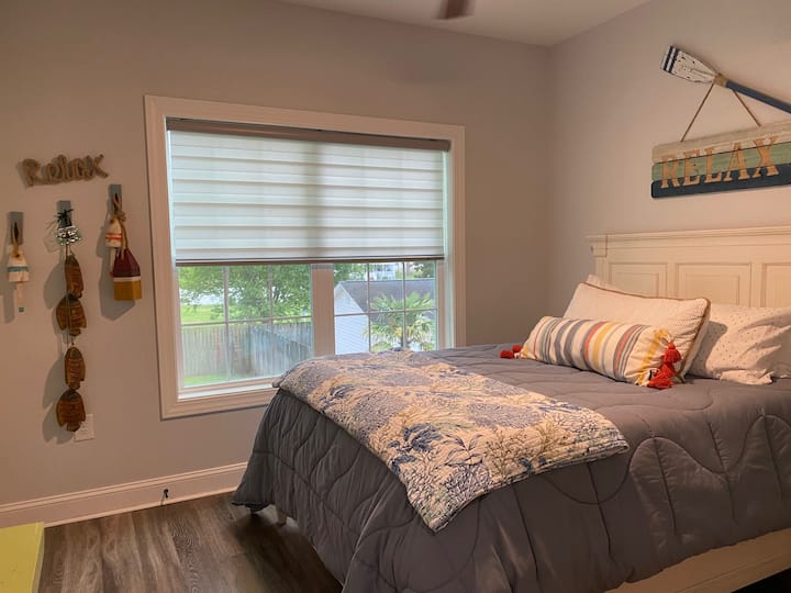 Queen size bed in one of two bedrooms on the first floor.