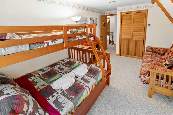 Kids room. We are SUPER baby & toddler friendly. Bunk bed is a twin on the top, full in the middle and a twin trundle. There is also a futon and a pack & play in this room. Changing table and diaper trash available.