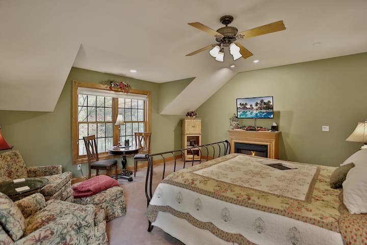 The Winterberry Room with king-size bed, TV, electric fireplace, comfortable seating and a private deck.