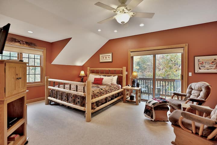 The Aspen Room with king-size bed, TV, electric fireplace, comfortable seating and a private deck.