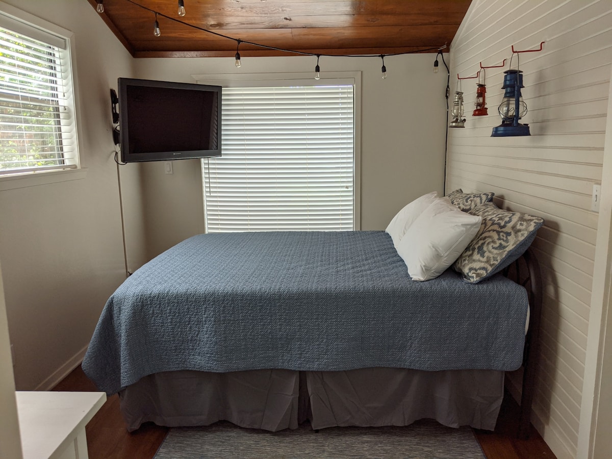 This charming, bright bedroom, with its unique maritime décor and TV, provides a snug harbor after a day on the lake.