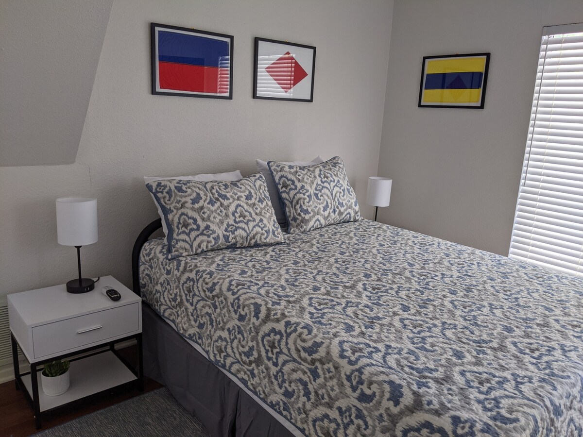 Drift into dreams in this cozy bedroom adorned with nautical accents, offering peace with plush comfort.