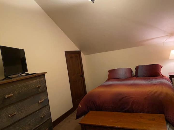 Bedroom 2 with Queen Bed, TV, and Desk/office space