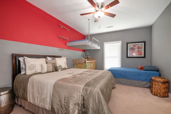 Bedroom #3 main floor.  1 queen bed,  2 tween beds,  crib