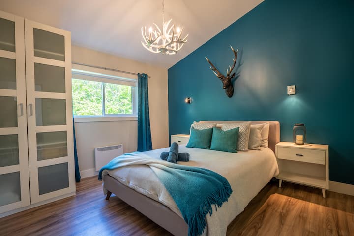 Chumba cha Asili, kilichopambwa kwa mandhari ya kulungu, kinatoa dari ya kanisa kuu, meko ya umeme na kitanda cha malkia kwa usiku wenye amani na starehe.