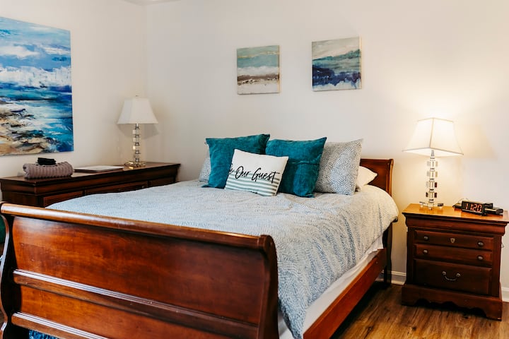 Our home has 2 en suites.  The first floor suite features a queen sleigh bed, large dresser, and a desk/workspace.