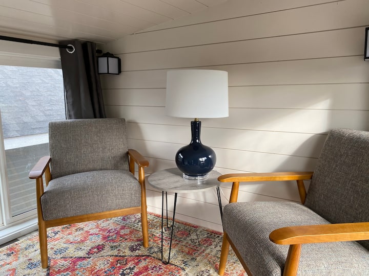 The living room is a cozy place for two people to enjoy their morning coffee.