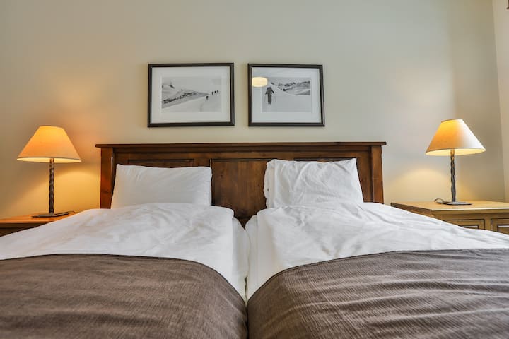 Segundo dormitorio con dos camas individuales y baño completo.