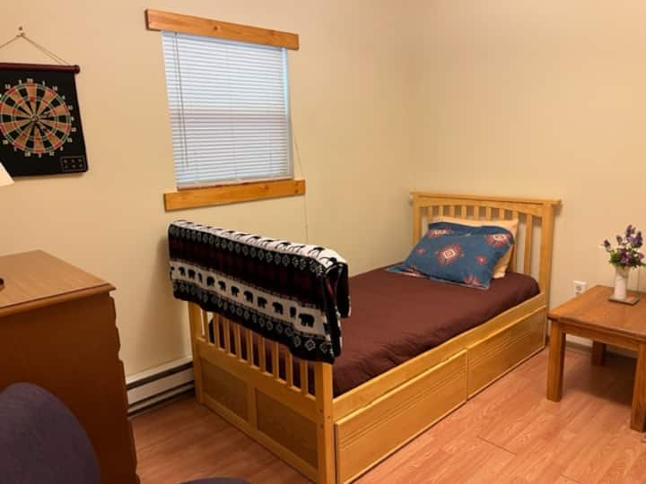 The third bedroom also has a dresser., a small table and hooks to hang your clothes. 