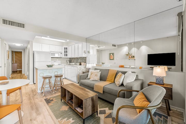The open concept living/kitchen area allows for all guests to hang out together .