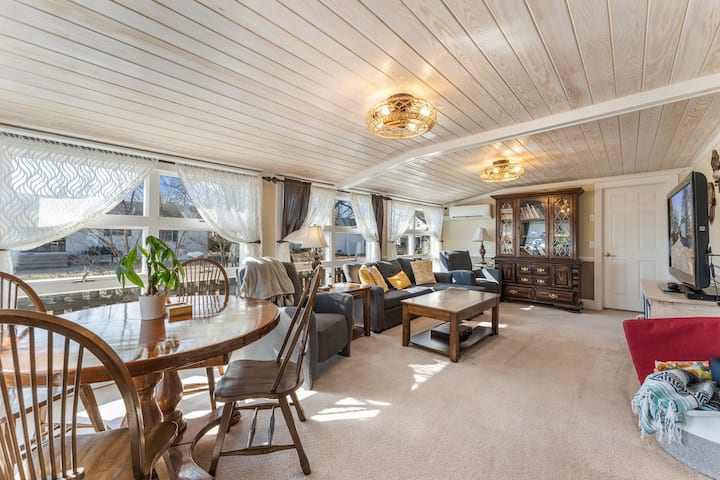 Newly renovated second living room & media room with shiplap ceilings, large TV, recliners and game table.