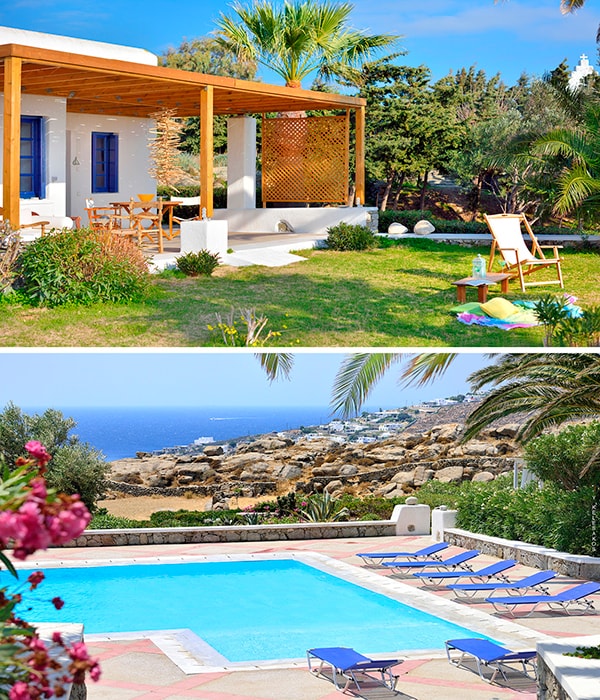 An outdoor terrace is featured under a wooden pergola, surrounded by lush greenery and palm trees. The setting includes comfortable seating arrangements. Below, a swimming pool with clear blue water is surrounded by sun loungers, with rocky coastline and the Aegean Sea visible in the background.