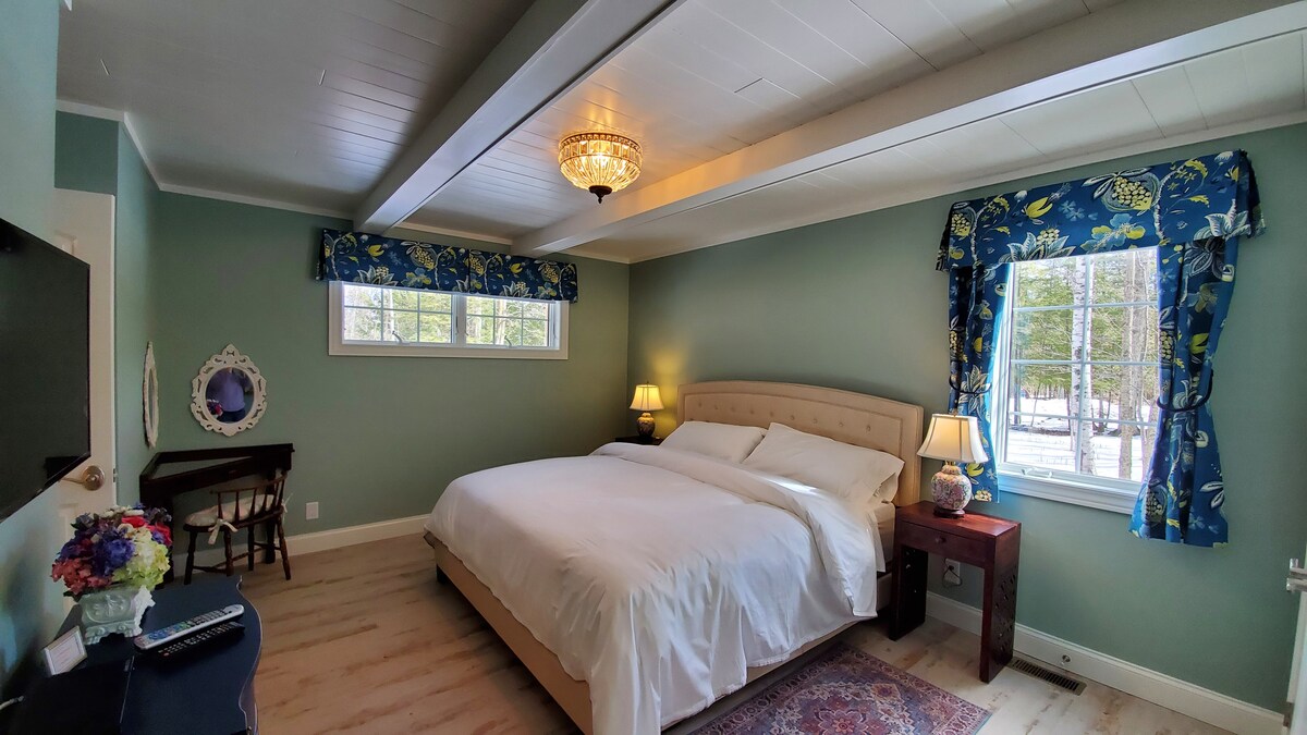 The large master bedroom has a king sized bed, dressing area and black out shades. 