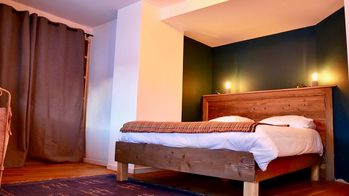 Large bedroom with a double bed and a baby cot