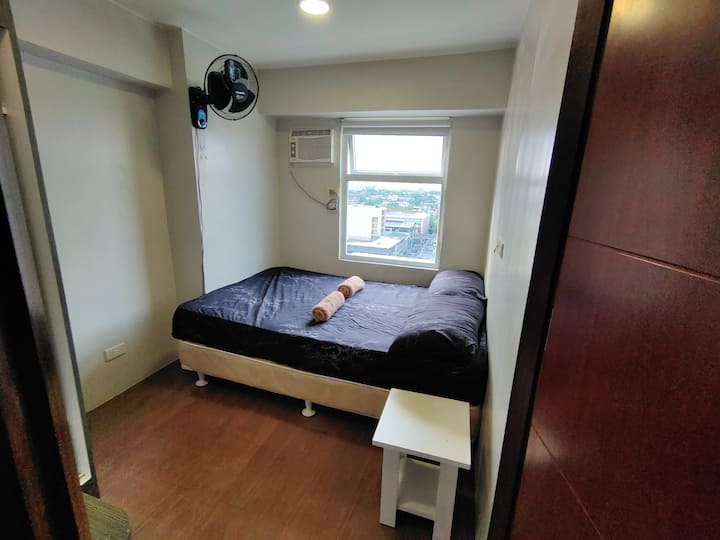 Rest with privacy in Bedroom 1 on the 2nd level, furnished with a queen-size bed and offering a beautiful outside view.