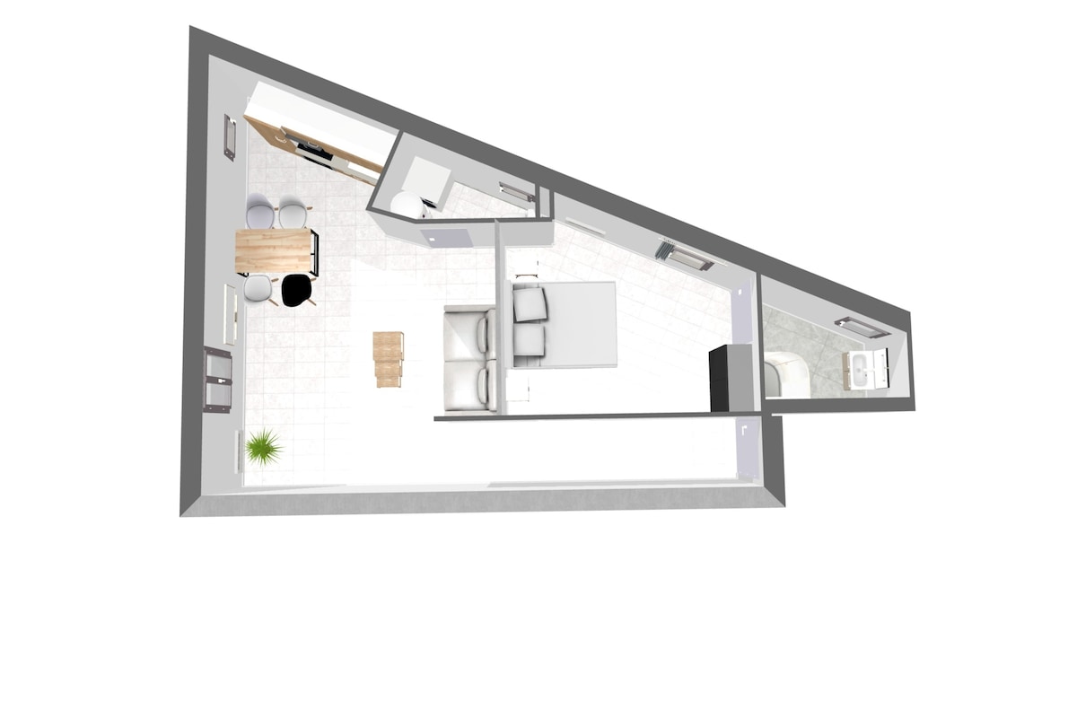 An overhead view of the spacious apartment layout is presented, with a kitchen area featuring sleek cabinetry and a dining table for four. The living area contains a comfortable sofa, and a separate bathroom is conveniently located. The design showcases a functional flow throughout the space.