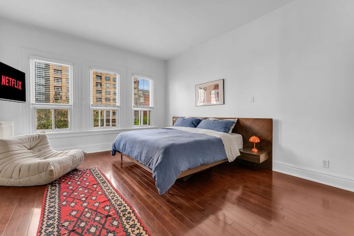 Master bedroom includes comfortable king bed and tv.