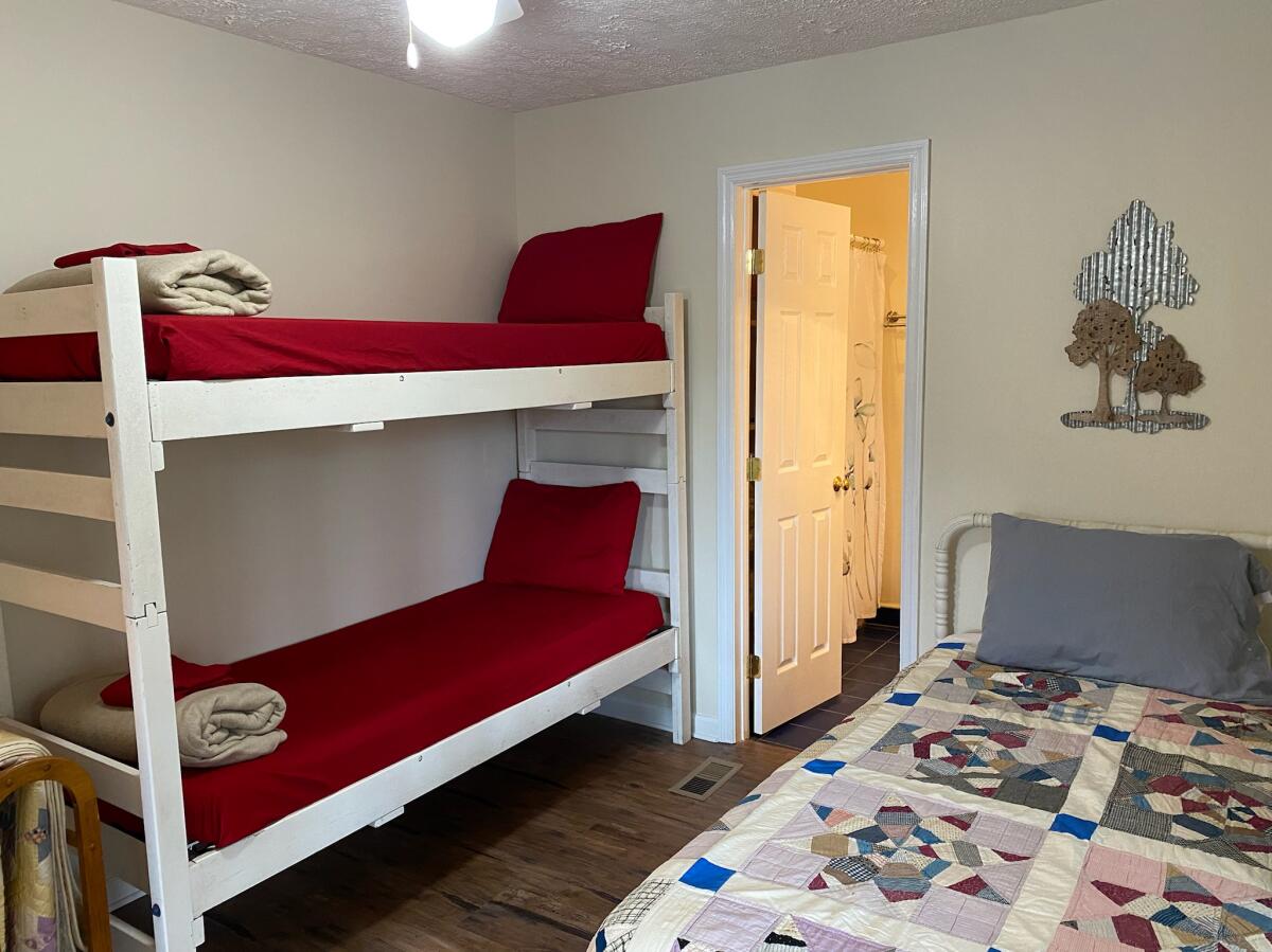 Has a twin and a bunk bed, sliding door access to bedroom 3 as needed to make a family suite, and a contained bathroom.