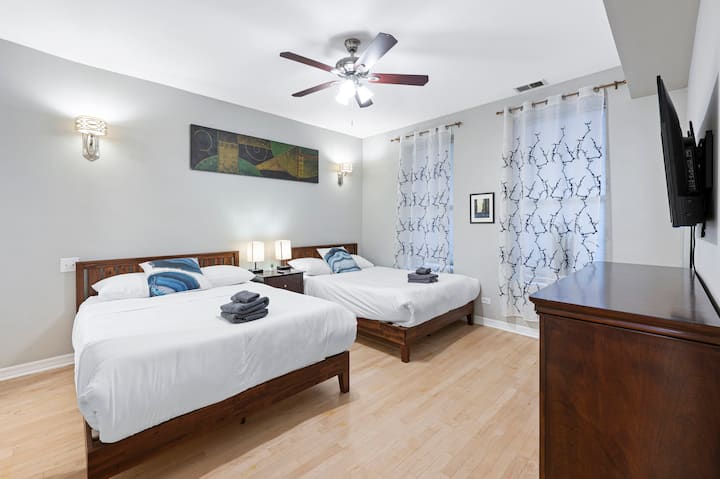 Chumba cha kulala kilicho na vitanda viwili vya malkia vilivyofungwa kwenye bafu kuu lenye mabaki mawili.