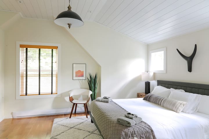 Primary bedroom on second floor with king bed and ensuite bath. Large closet and dresser.