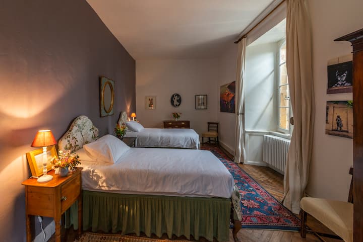 This bedroom's gentle lighting and soft textiles provide a peaceful setting, ideal for relaxation after a day of château exploration. Bedroom #5 has two single beds.
