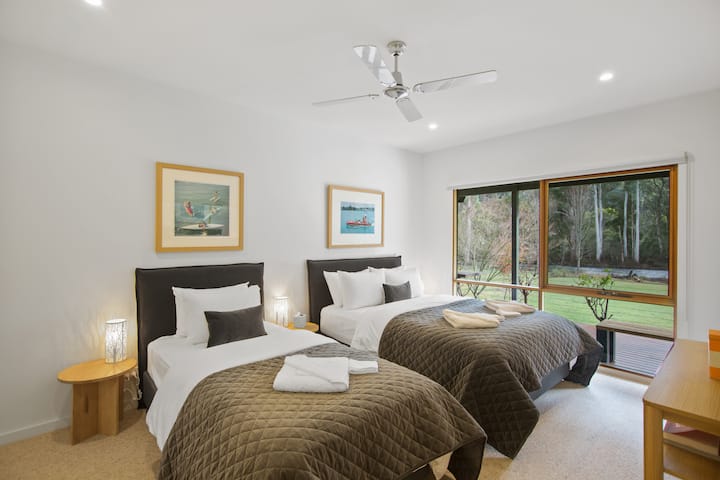 Third Bedroom - with direct view to the Delatite River.  This room has 1 queensize bed and 1 King Single direct access to retreat and games.