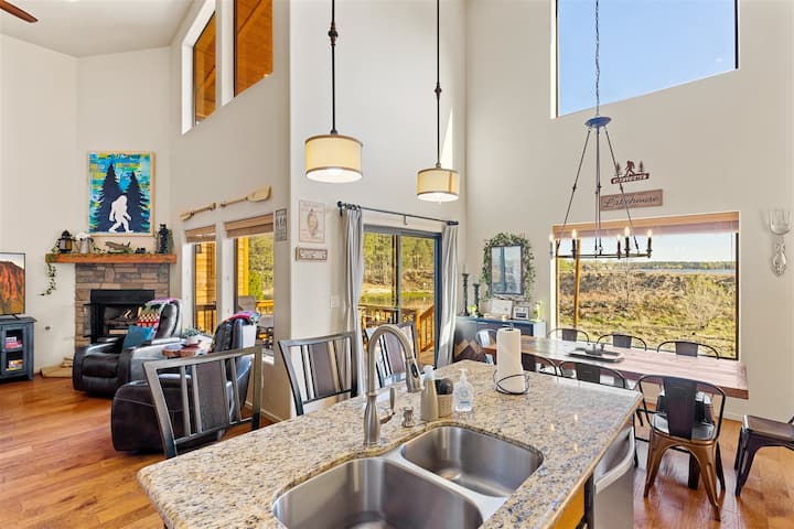 Grumpy Toads Getaway open plan living — kitchen island, fireplace, and lake views