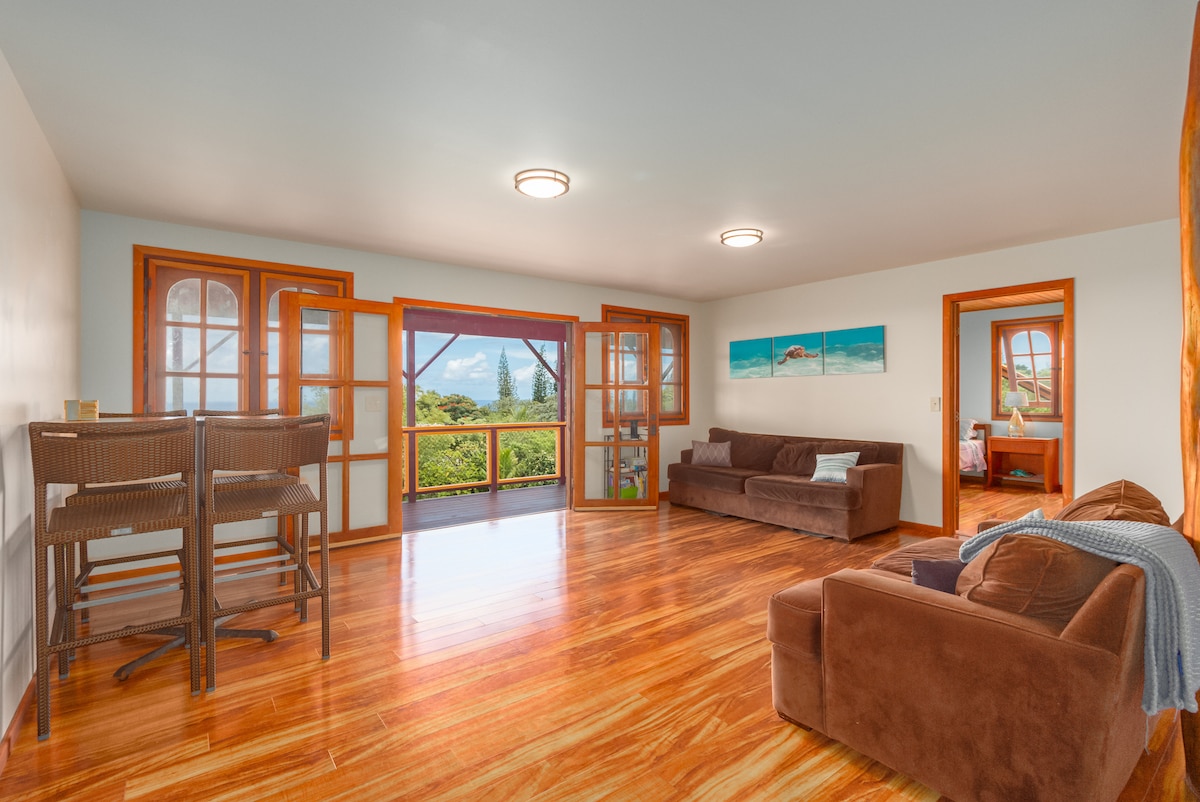 Private living room, bar height dining table, and French doors opening out to your private lanai