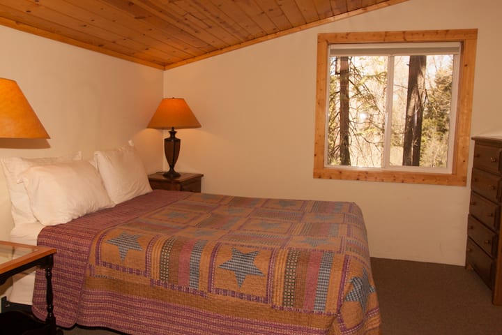 Queen bed in upstairs bedroom.