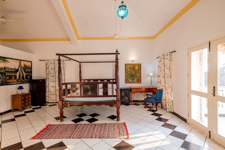 This room is designed to maximize the connection with nature, with large windows allowing natural light to flood in and provide a sense of serenity. The bed in this room is comfortable and regal, ensuring a restful night's sleep while enjoying views