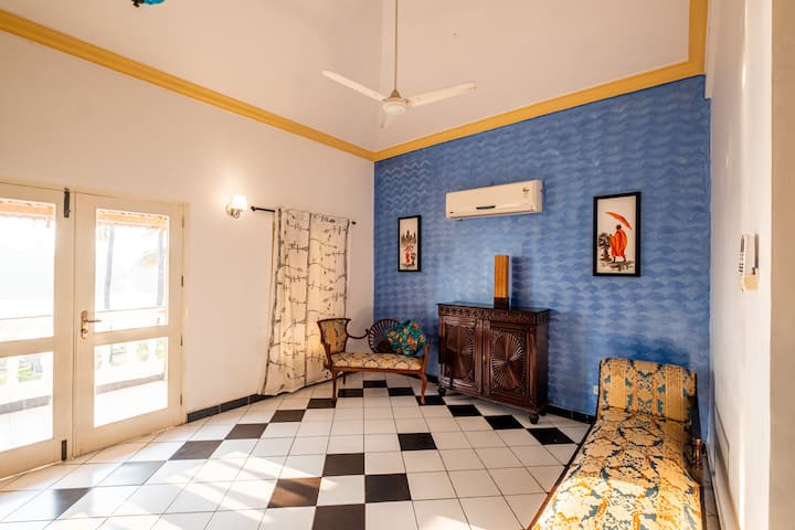 The gentle sunlight streaming through the glass door creates a peaceful atmosphere, casting a warm glow on your face. As you sit in the cozy space, you can feel the soft caress of the sun's rays, enveloping you in a comforting embrace.