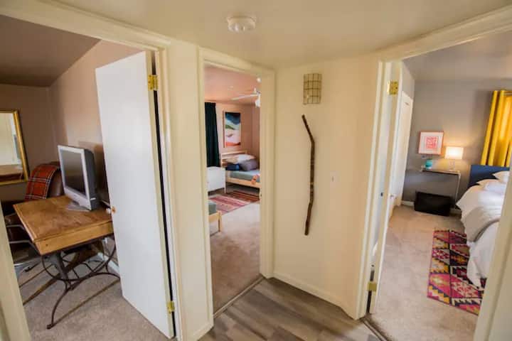 Views into our 3 bedrooms. King master with en-suite bathroom is to your right. The kids room with two twin beds is in the middle and the other king bedroom is to the left. 