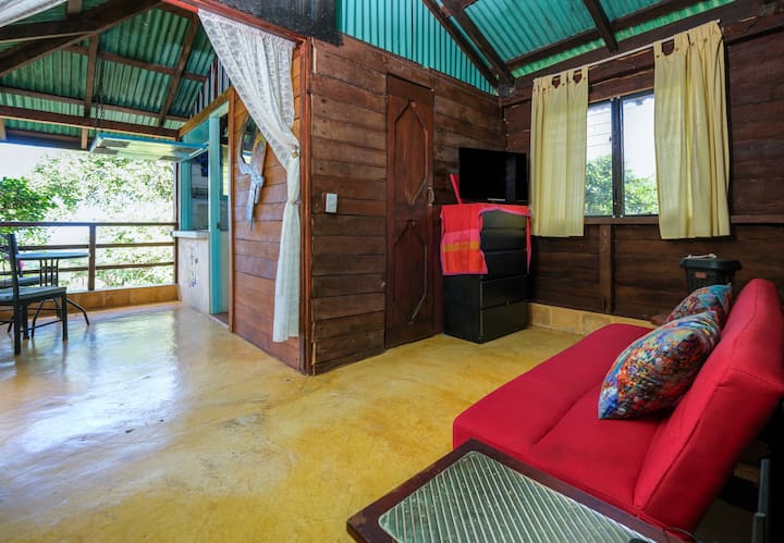 Living room opens to the terrace with wooden doors.