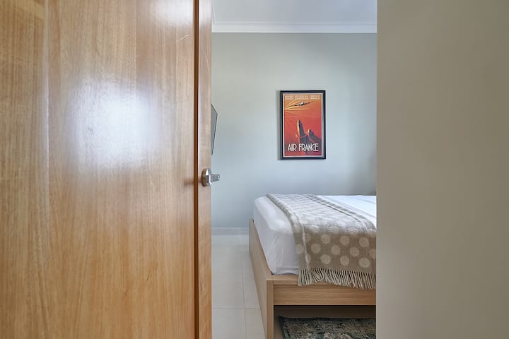 Det hyggelige soveværelse har queensize-dobbeltseng, privat badeværelse med regnbruser, rummeligt skab, aircondition, 43 TOMMER smart-tv og hurtig WI-FI.