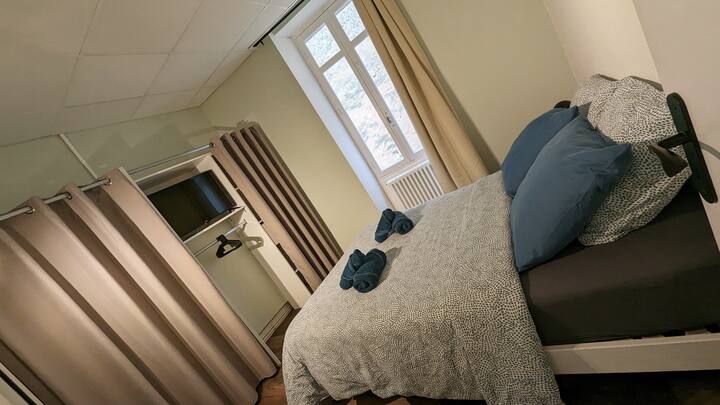 Bedroom 1 with double bed, TV, dressing room and fan.