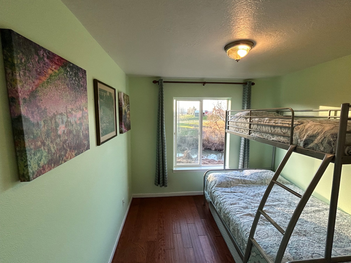 The green room Creekside bedroom that sleeps 4 and has 4 drawer log dresser and walk in closet