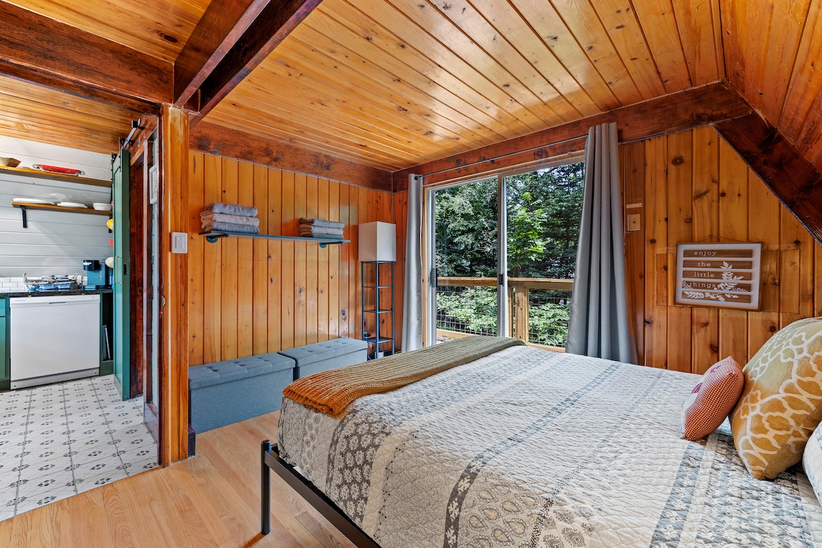 Main floor bedroom with large balcony access. - Queen Bed