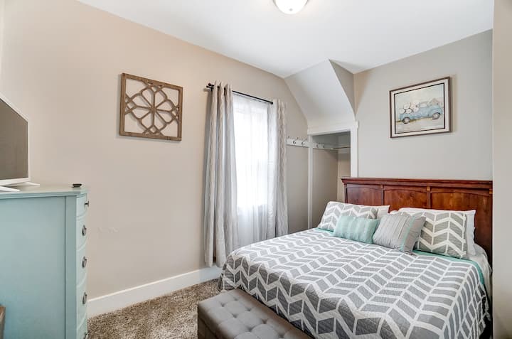 Downstairs bedroom featuring 1 queen bed and 32" Smart TV. Sleeps 2.