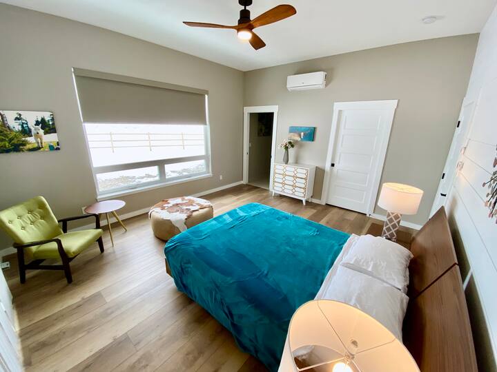 Master bedroom.  Enjoy a restful night on the low-profile, platform bed with queen-size, memory foam mattress. Doorway on the left leads to the bathroom, while the one on the right leads to the walk-in closet.  
