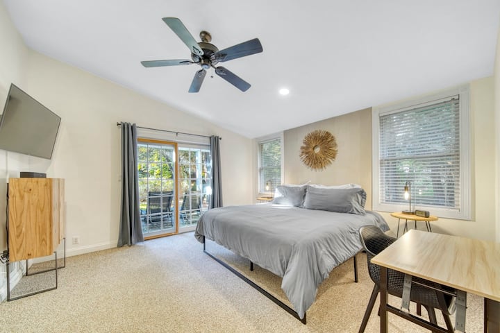 Primary bedroom with king-size bed and working space. 