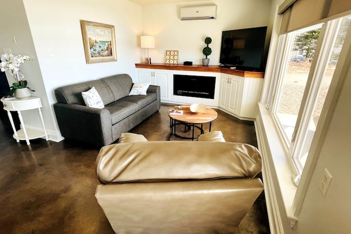 Living room with sofa bed, electric fireplace, smart tv, beautiful view of the ocean and AC for the summer!