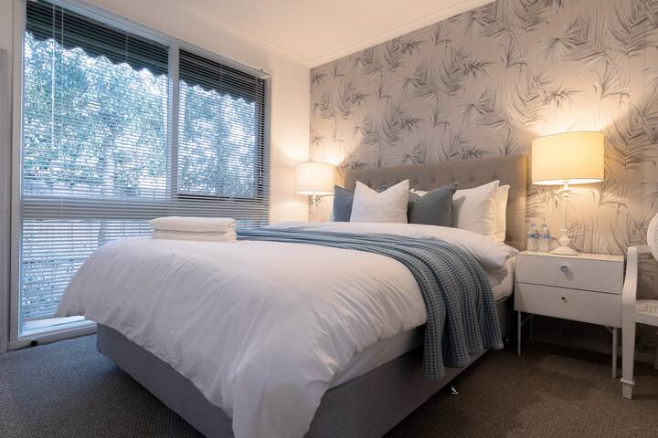 Second bedroom with a big light window, queen bed and wardrobe is perfect to accommodate extra guests. Quality lofty bed to make sure you have a good night sleep. 