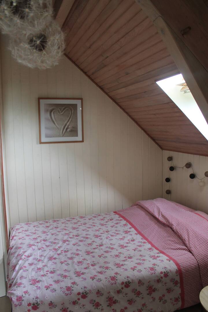 Bedroom adjoining a balcony with pool view.