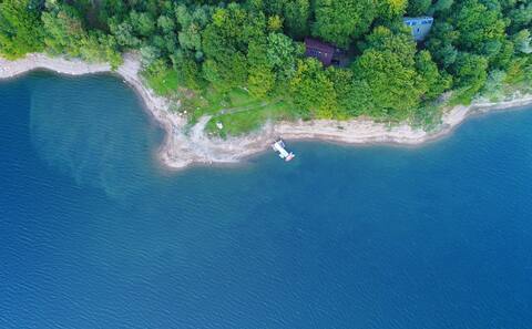 Lake cabin with floating pontoon, outdoor hot tub.