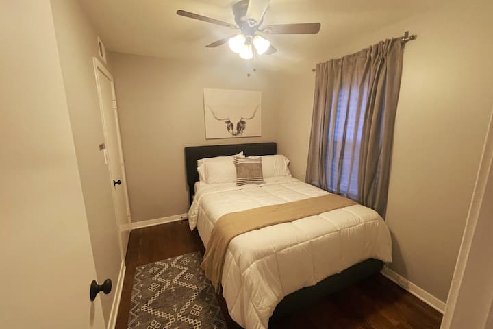 Bedroom #3 features a comfortable bed,  a ceiling fan with controls on the light switch, and a 32 inch smart tv. This room also features access to the kitchen. If you're a foody, you'll love this room.