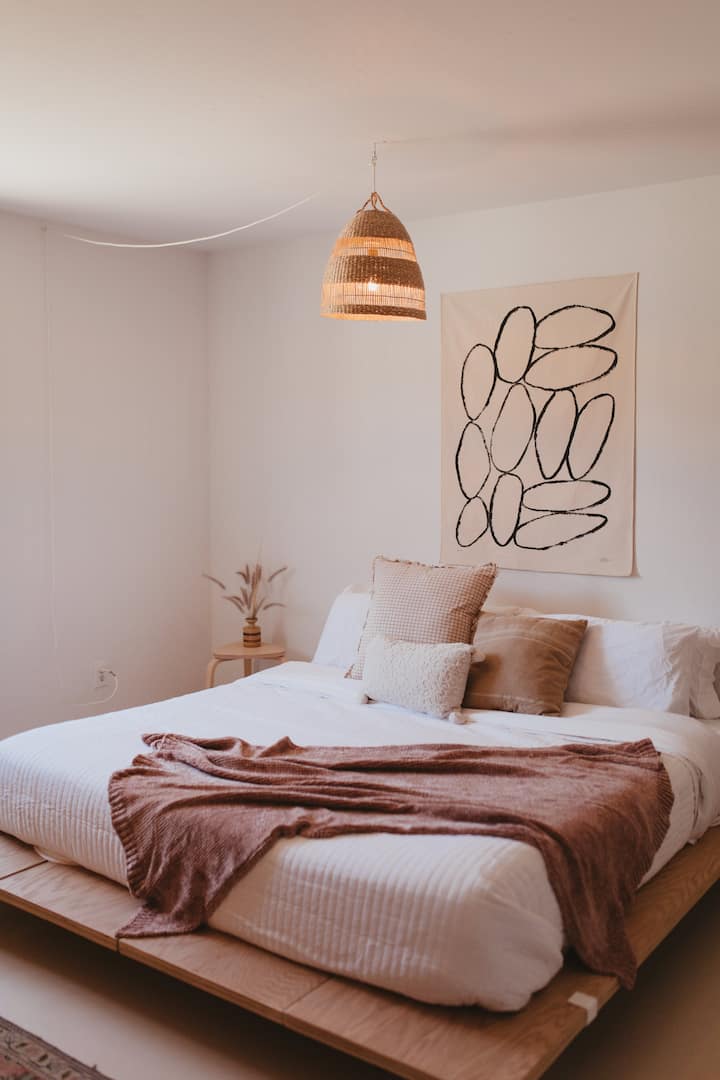 Main bedroom with king Leesa mattress, on a custom made floating platform bed, designed with thoughtful fixtures and decor. You won't want to leave this spot in the morning!