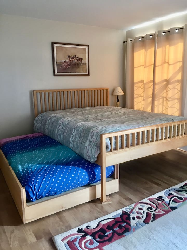 Trundle twin bed pulls all the way out.  Mattress can be used on the floor in living room if that works better for guests.