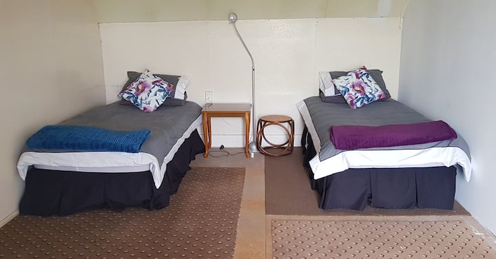 "OLD WING" (unrenovated, cheap & cheerful) ATTIC BEDROOM up half a flight of stairs from the huge main upstairs bedroom. 2 x Single Beds (that can be pushed together to create a make-shift SuperKing).