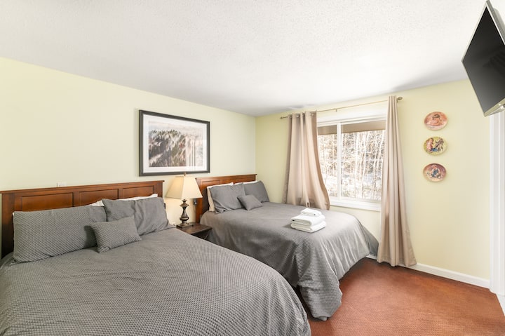 спална соба со двоен кревет со паметен телевизор, сопствена бања